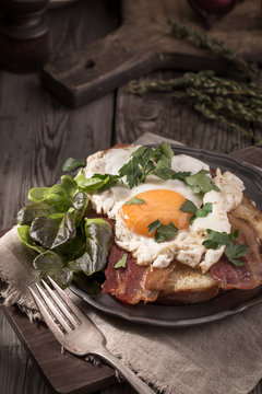 Bacon and egg toast in rustic style