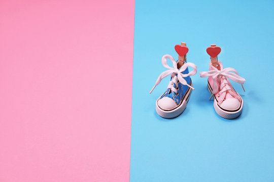 Baby Sneakers On Pink And Blue Background, Boy Or Girl Concept
