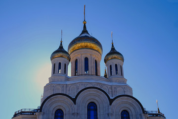 Fototapeta na wymiar Church domes covered with gilding, blue sky