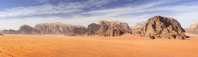 Wall murals Drought panoramic view to red sand desert with mountains rocks in Jordan