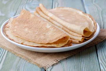 Dish with pancakes, close-up, side view