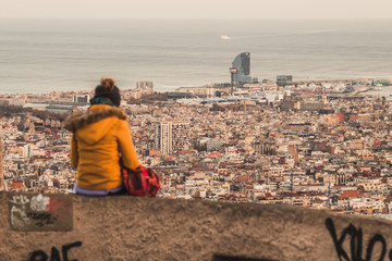 Fototapeta na wymiar A girl admiring Barcelona's skyline.