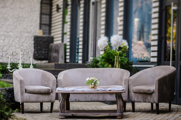 Outdoor composition from vintage sofa and armchair