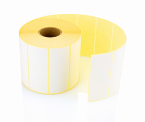 White label roll isolated on white background with shadow reflection. White reel of labels for...