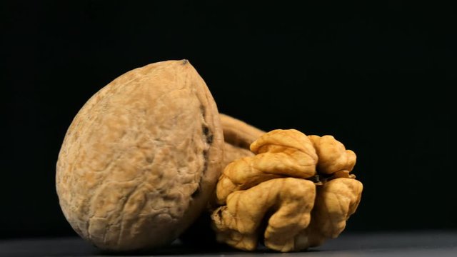 Walnuts nuts in rotation on black background.