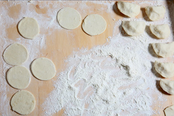 Dumplings homemade cheese and potatoes on a pastry board 