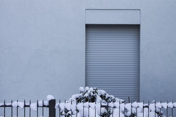 Isolated window background and a snowy grating (Pesaro, Italy)