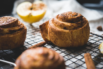 cinnamon rolls on the stone table, decoration with apples and cinnamon