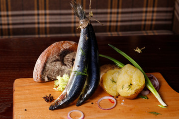 Herring, potatoes, onions, on a cutting Board .