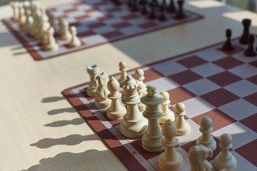 Chess tournament tables with chess timers and blank note papers