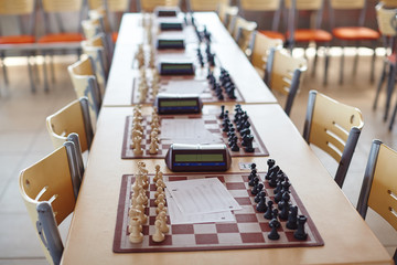Chess tournament tables with chess timers and blank note papers