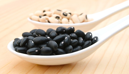 Black beans in spoon on table