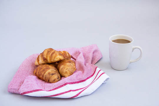 Croissants On A Red Tea Towel With A Cup Of Coffee 