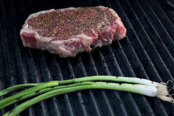 grilling steak with green onions