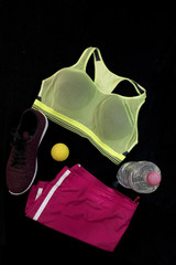 Sport clothes and accessories on black background