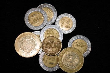 Mexican coins on a black background