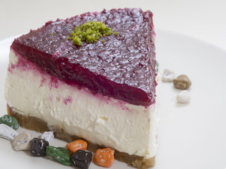 wet cake cut above the triangular pie with strawberry sauce