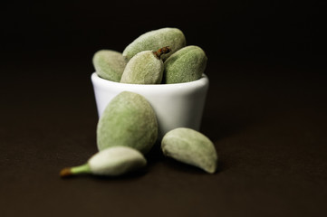 Raw, unpeeled, green almonds