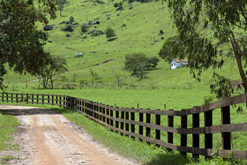 Fototapeta na wymiar Rural landscape with fence and house