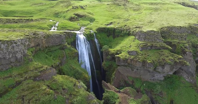 Flight over popular Icelandik attraction. 4K footage of waterfall in Iceland.