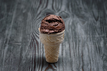 chocolate ice cream with cone on wooden background background