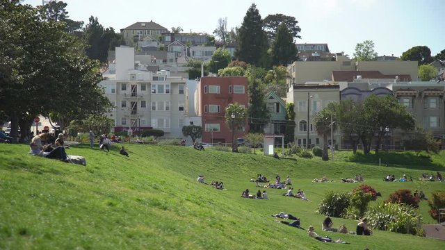 People lying on grass in Dolores Park
