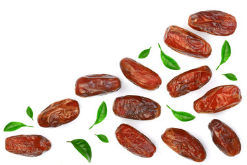 dry dates decorated with leaves isolated on white background with copy space for your text. Top view. Flat lay pattern