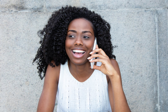 Laughing african american woman at cellphone