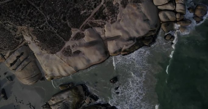 4K high quality aerial video footage of Western Cape's coast, Paternoster beach boulders, sandy sea front and Atlantic Ocean views in the background near Cape Town, South Africa on summer morning