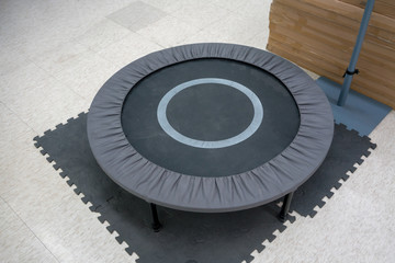 Fototapeta na wymiar small grey and black fitness trampolin on foam sheet