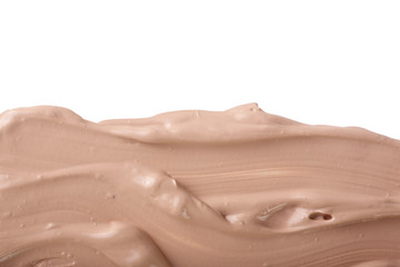 Beige liquid foundation makeup isolated on white background with copy space for your text. Top view. Flat lay pattern