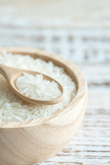 Fototapeta na wymiar Jasmine rice in a wooden bowl on wooden