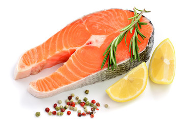 Slice of red fish salmon with lemon, rosemary and peppercorns isolated on white background