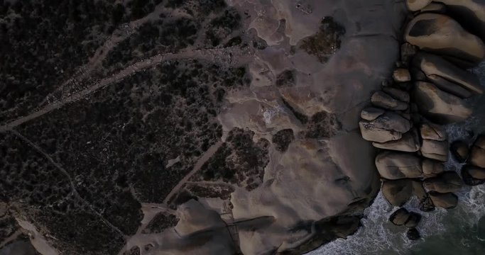 4K high quality aerial video footage of Western Cape's coast, Paternoster beach boulders, sandy sea front and Atlantic Ocean views in the background near Cape Town, South Africa on summer morning