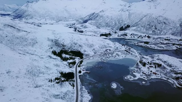 View of mountain landscape in Northern Norway, Lofoten Islands, Nordland, on the way to Ryten mountain and Kvalvika beach, with a groups of hikers, and mountains around, sunny winter day
