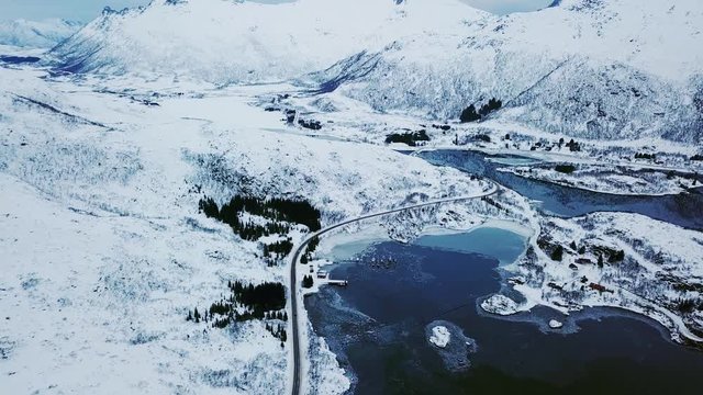 View of mountain landscape in Northern Norway, Lofoten Islands, Nordland, on the way to Ryten mountain and Kvalvika beach, with a groups of hikers, and mountains around, sunny winter day
