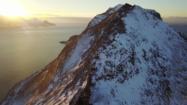 View of mountain landscape in Northern Norway, Lofoten Islands, Nordland, on the way to Ryten mountain and Kvalvika beach, with a groups of hikers, and mountains around, sunny winter day
