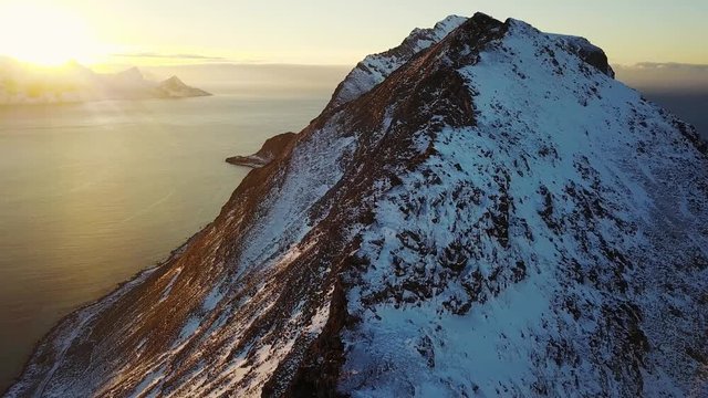View of mountain landscape in Northern Norway, Lofoten Islands, Nordland, on the way to Ryten mountain and Kvalvika beach, with a groups of hikers, and mountains around, sunny winter day
