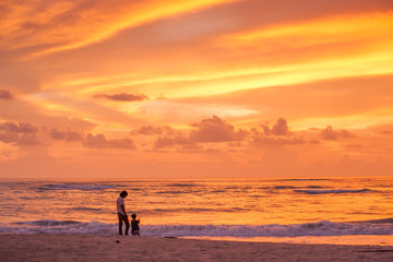 Fototapeta na wymiar Father and son relaxing at the sunset beach.