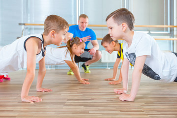 Children at physical education lesson in school gym gymnast kid