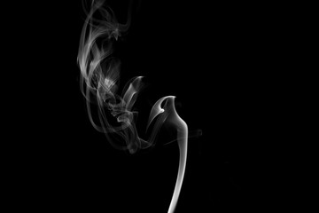 Smoke the white incense on a black background. darkness concept