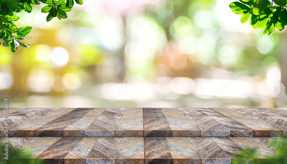 Aufkleber Empty step plank wood table top with blur tree in park with bokeh light background and leaves foreground,Mock up template for display of your design,Banner for advertise of product,panorama view