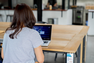 Business woman and computer in coffee shop