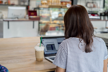 Business woman and computer in coffee shop