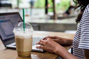 Business woman and computer in coffee shop