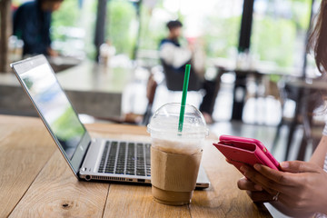 Business woman and computer in coffee shop