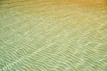 sand texture with reflection on sea golden sunset time ,beach