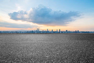 empty concrete floor and modern buildings in midtown of singapore in blue cloud sky