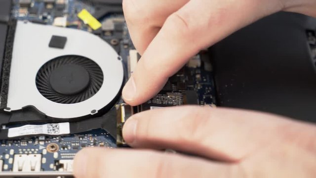 Installing the SSD Disk into the msata slot on the laptop. Installing a hard drive on a laptop. Laptop repair.