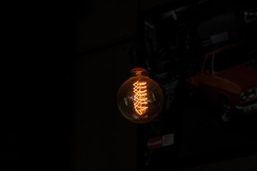 Fototapeta na wymiar Vintage Light Bulb On Black Background